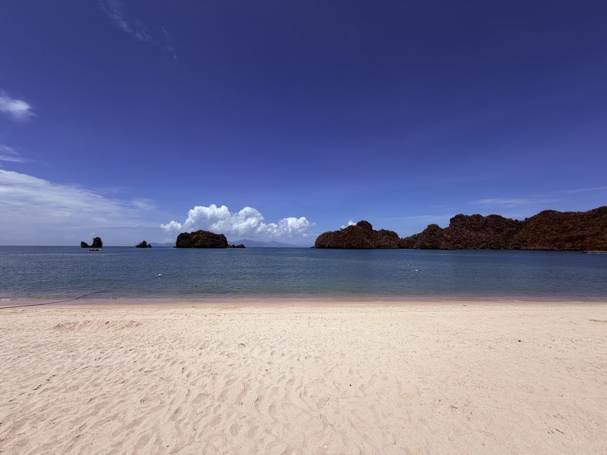 the langkawi beach and the karst islands with the deep blue ocean by a beach of golden sand